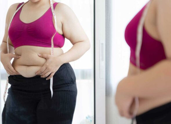 women-look-into-mirror-at-fat-belly