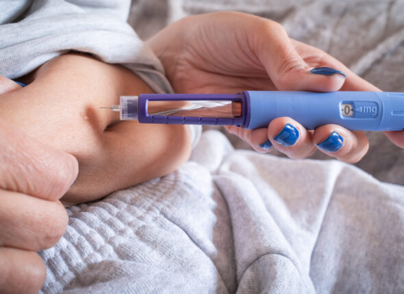 unrecognizable mature overweight diabetic woman injecting a syringe of semaglutide into her belly.medication for the medical treatment of obesity.